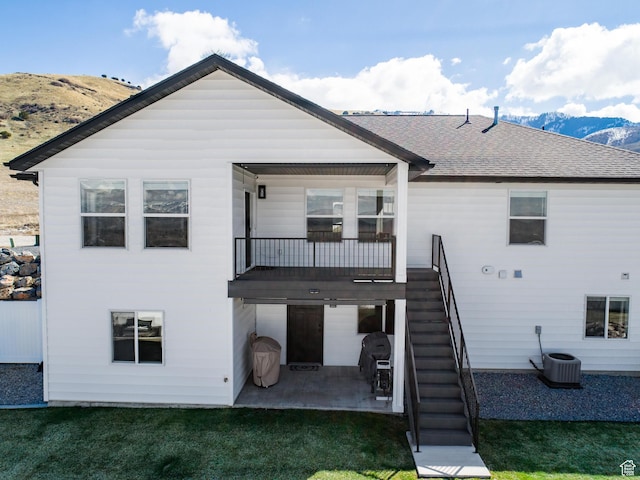 51 S 1250 E, Smithfield, UT 84335 - rear view of house featuring a patio area, a mountain view, a lawn, and stairs