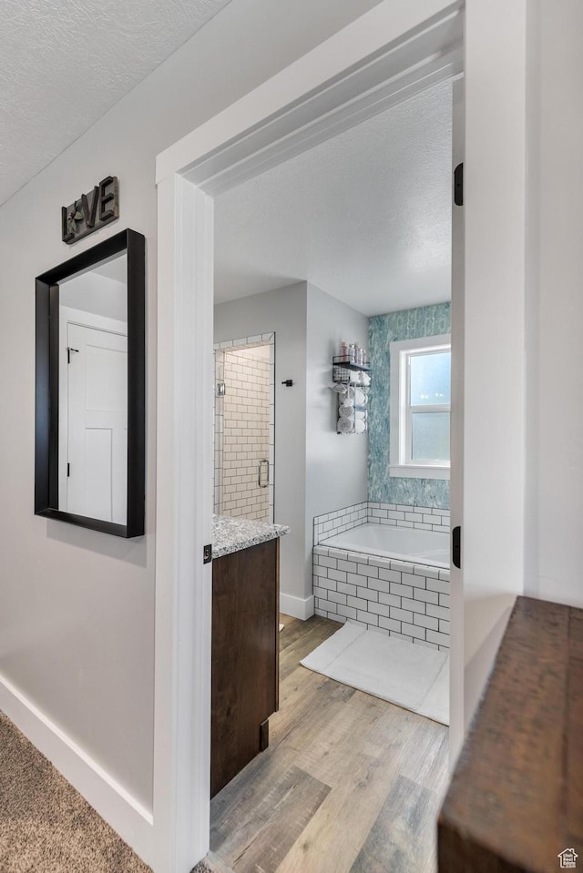 51 S 1250 E, Smithfield, UT 84335 - full bath featuring baseboards, a textured ceiling, vanity, wood finished floors, and a garden tub
