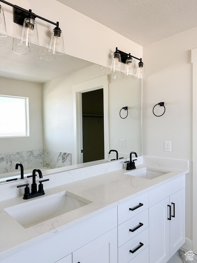7007 W Hazel Oak Ct Unit 212, Herriman, UT 84096 - bathroom featuring double vanity and a textured ceiling