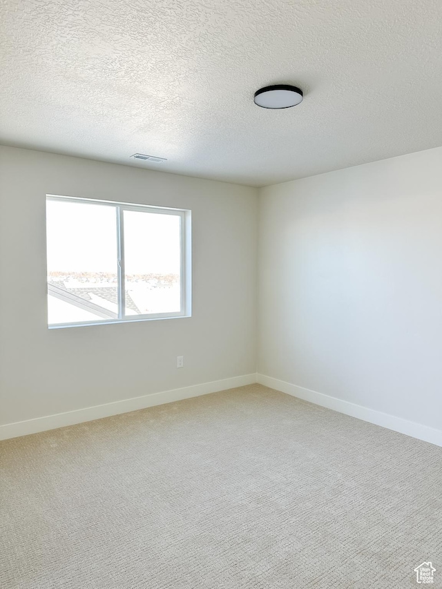 7007 W Hazel Oak Ct Unit 212, Herriman, UT 84096 - spare room featuring a textured ceiling and light carpet