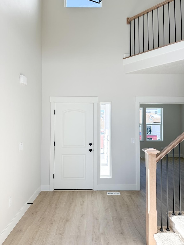 7007 W Hazel Oak Ct Unit 212, Herriman, UT 84096 - entrance foyer featuring a high ceiling, light wood finished floors, and stairs