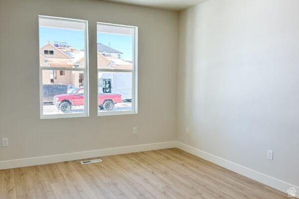 7007 W Hazel Oak Ct Unit 212, Herriman, UT 84096 - unfurnished room featuring light wood-style floors and baseboards