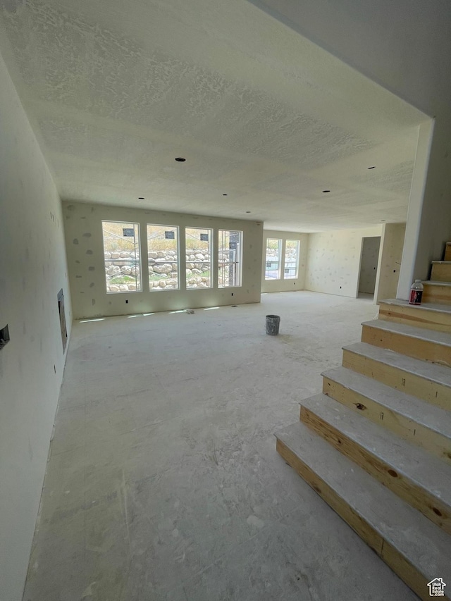 7007 W Hazel Oak Ct Unit 212, Herriman, UT 84096 - unfurnished living room featuring stairway and a textured ceiling