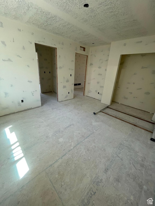 7007 W Hazel Oak Ct Unit 212, Herriman, UT 84096 - unfurnished bedroom featuring a textured ceiling