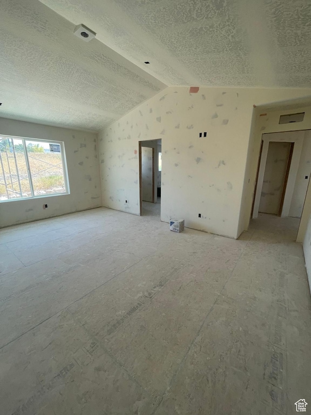 7007 W Hazel Oak Ct Unit 212, Herriman, UT 84096 - unfurnished room with lofted ceiling and a textured ceiling