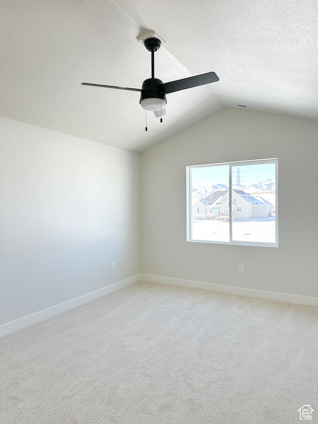 7007 W Hazel Oak Ct Unit 212, Herriman, UT 84096 - empty room featuring a ceiling fan, vaulted ceiling, a textured ceiling, and light carpet