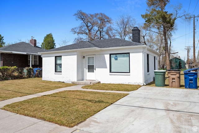 924 W California Ave, Salt Lake City, UT 84104 - bungalow with brick siding, a chimney, and a front lawn