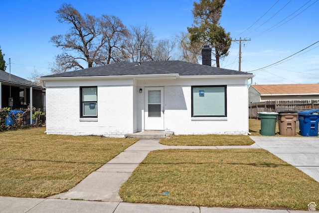 924 W California Ave, Salt Lake City, UT 84104 - bungalow-style house featuring a chimney, fence, brick siding, a front lawn, and roof with shingles