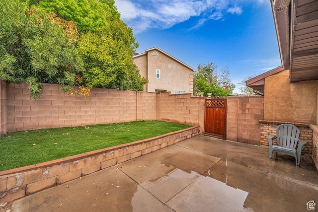 view of patio featuring a fenced backyard and a gate
