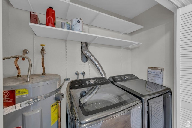 laundry area featuring independent washer and dryer, water heater, and laundry area