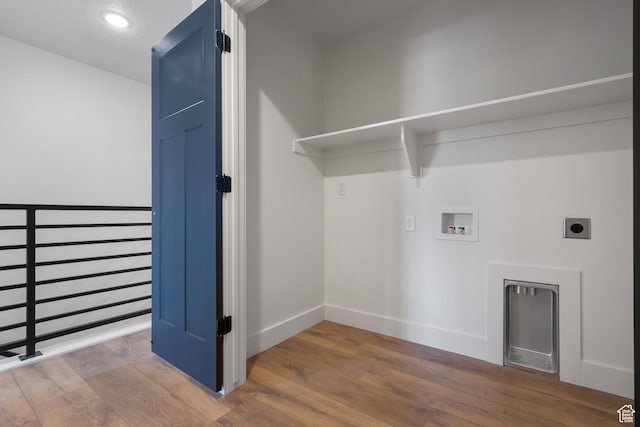 clothes washing area featuring wood finished floors, hookup for an electric dryer, baseboards, and hookup for a washing machine