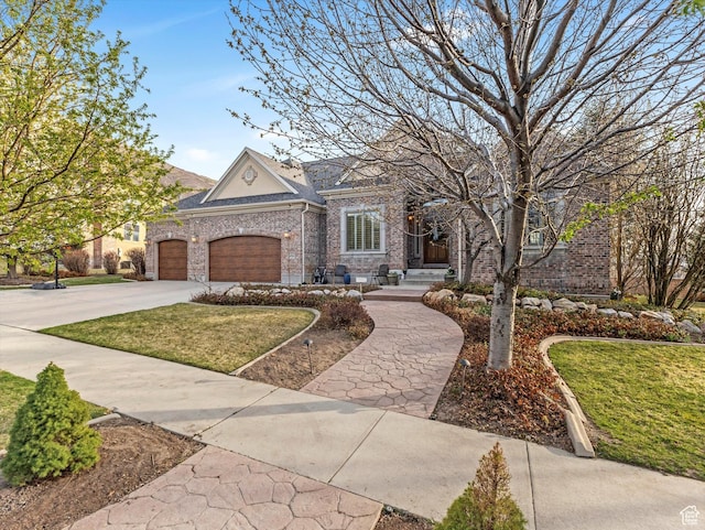 view of front of property featuring an attached garage, concrete driveway, a front yard, and brick siding