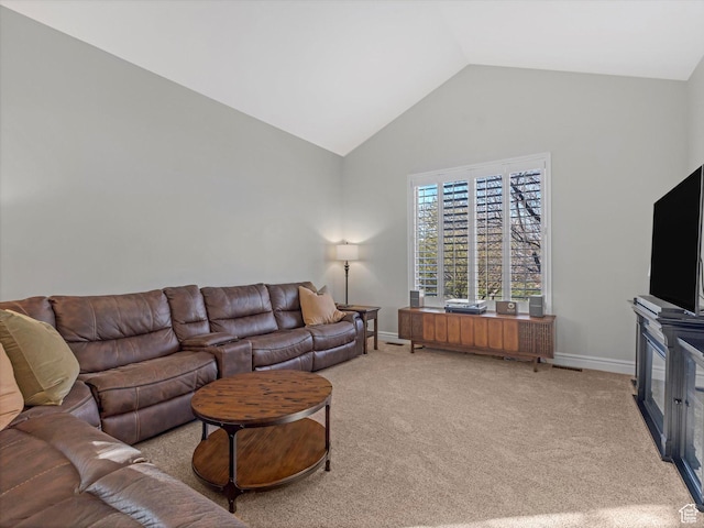 living area featuring carpet floors, baseboards, and high vaulted ceiling