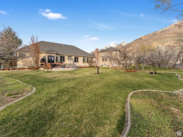 back of property featuring a yard and a patio area