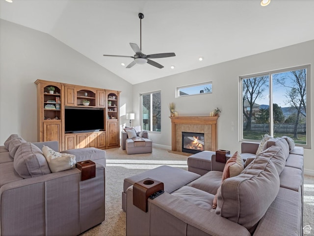 living area with ceiling fan, recessed lighting, a tile fireplace, and light colored carpet