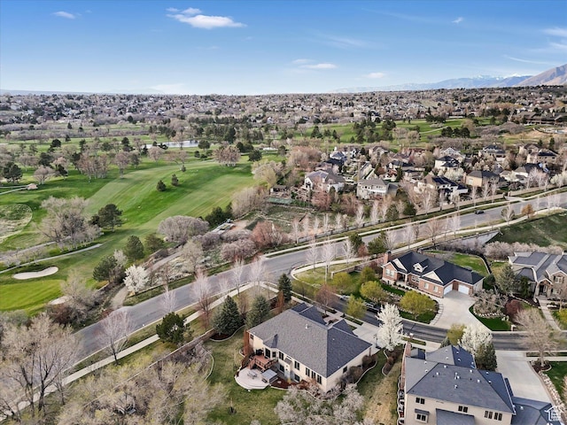 birds eye view of property with view of golf course, a mountain view, and a residential view
