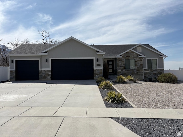 view of front of house featuring concrete driveway, stucco siding, stone siding, a garage, and fence
