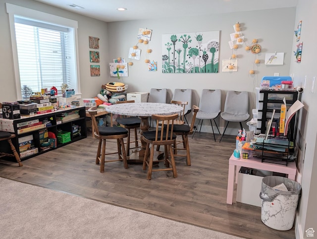 dining room featuring wood finished floors, visible vents, and recessed lighting