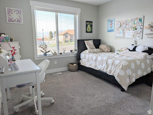 carpeted bedroom featuring baseboards, visible vents, and multiple windows