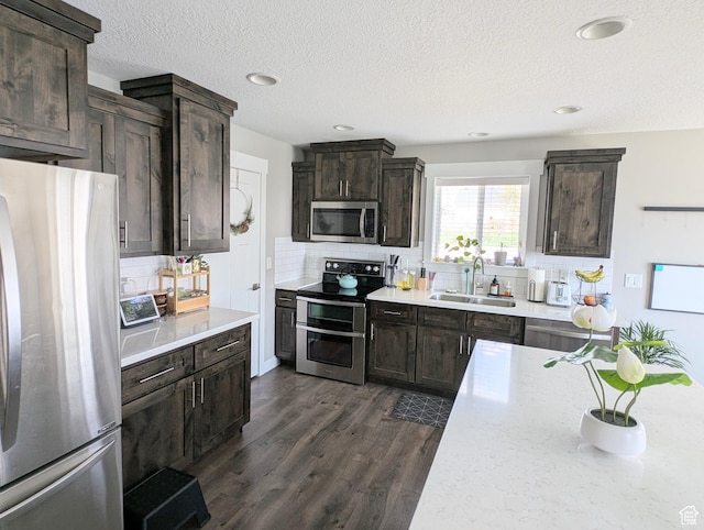 kitchen featuring backsplash, stainless steel appliances, and a sink
