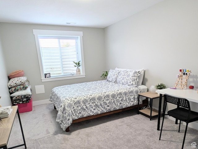 carpeted bedroom featuring visible vents and baseboards
