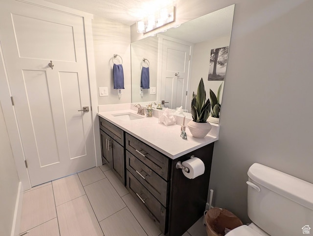 bathroom with toilet and vanity