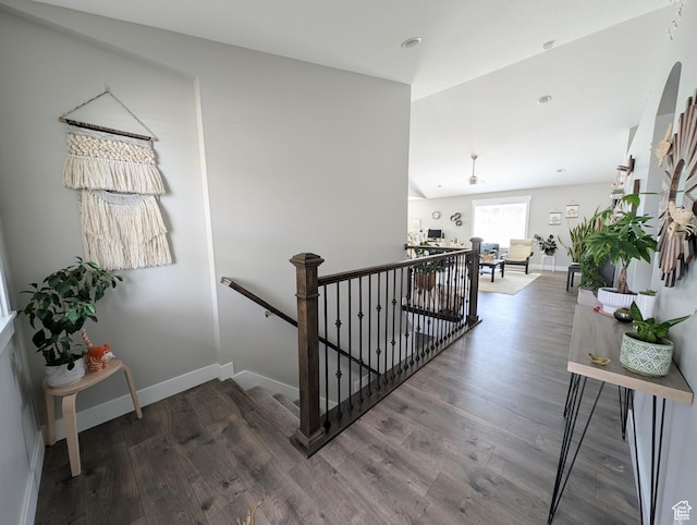 staircase featuring baseboards and wood finished floors