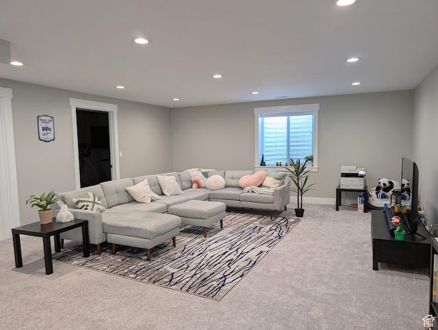 carpeted living area with recessed lighting and baseboards