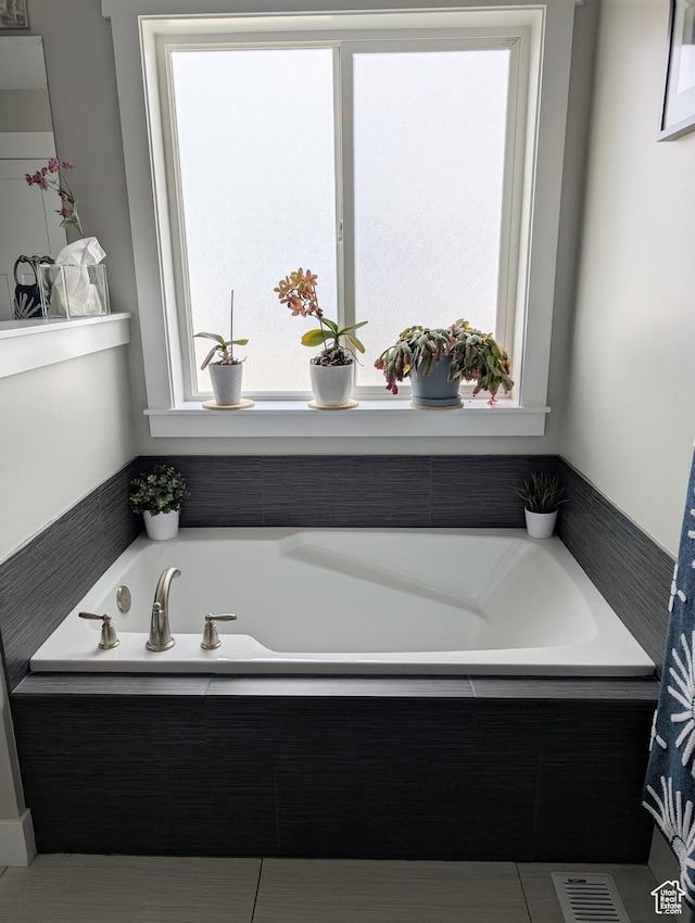 full bath featuring a bath and visible vents