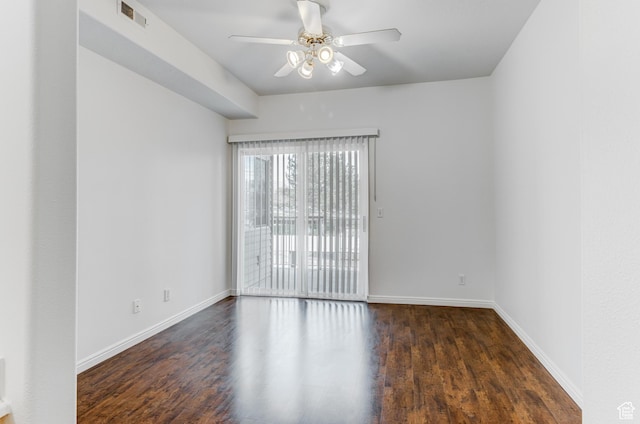 empty room with visible vents, ceiling fan, wood finished floors, and baseboards