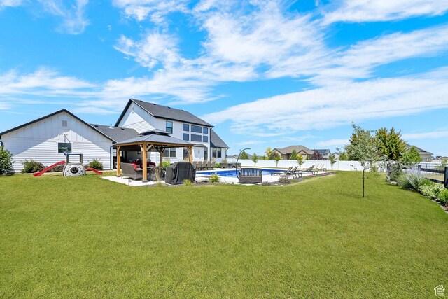 2282 N 3430 W, Clinton, UT 84015 - back of property with a gazebo, board and batten siding, a fenced backyard, and a patio