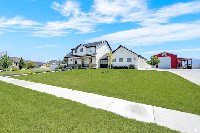 2282 N 3430 W, Clinton, UT 84015 - modern inspired farmhouse featuring board and batten siding, an outbuilding, a front yard, driveway, and a garage