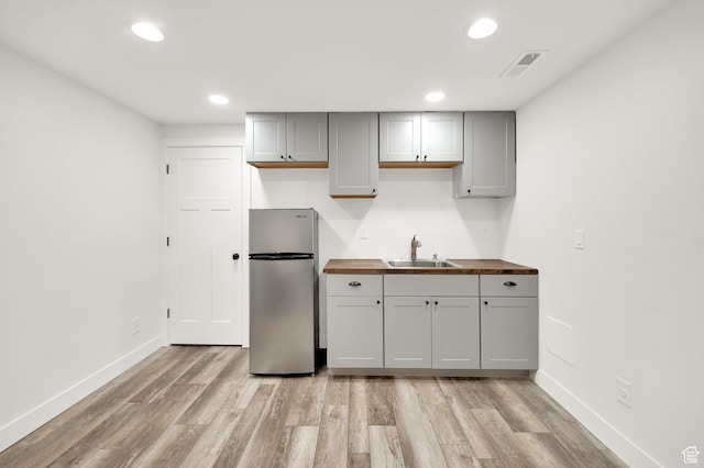 2282 N 3430 W, Clinton, UT 84015 - kitchen with freestanding refrigerator, butcher block counters, light wood finished floors, gray cabinetry, and recessed lighting