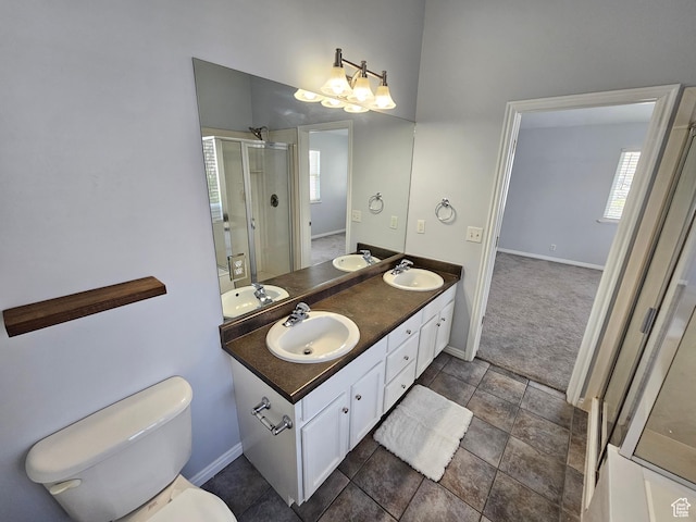 full bathroom with a shower stall, plenty of natural light, a sink, and toilet