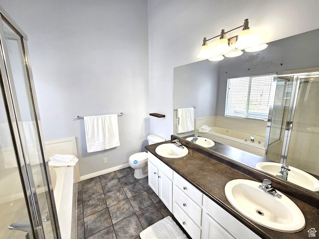 bathroom with a shower stall, double vanity, and a sink