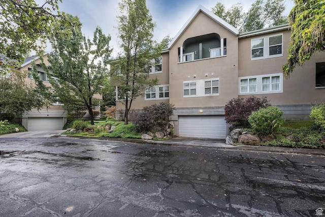 exterior space featuring driveway, stucco siding, and an attached garage