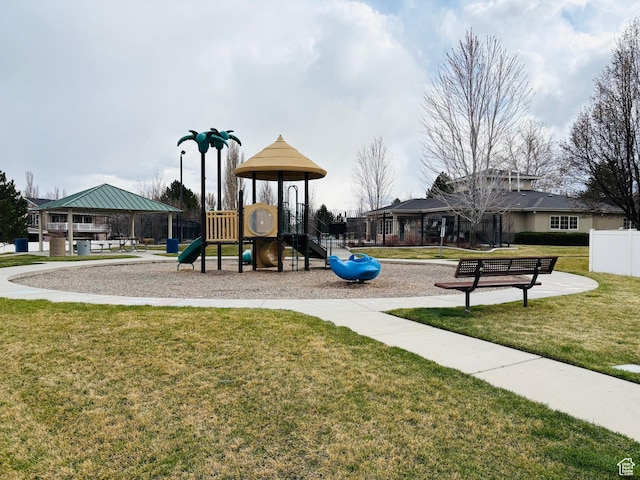 community jungle gym with fence and a lawn