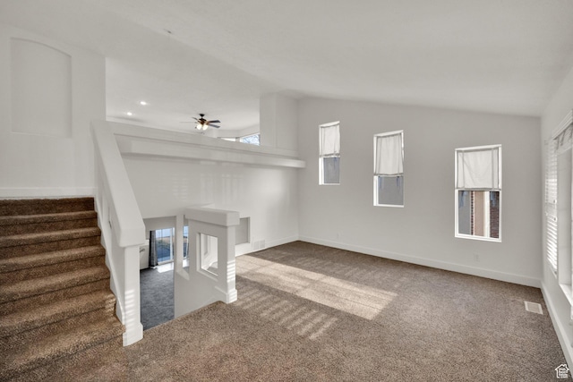 unfurnished living room with carpet floors, baseboards, a ceiling fan, and lofted ceiling