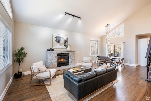 872 Martingale Ln, Park City, UT 84098 - living area featuring high vaulted ceiling, a stone fireplace, baseboards, and wood finished floors