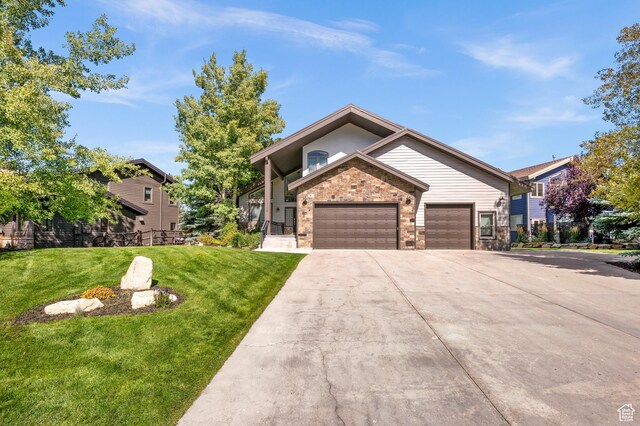 872 Martingale Ln, Park City, UT 84098 - view of front of home with brick siding, a front lawn, a garage, and concrete driveway