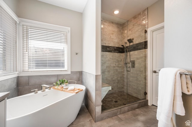 872 Martingale Ln, Park City, UT 84098 - bathroom with a stall shower, tile patterned floors, wainscoting, a freestanding bath, and tile walls