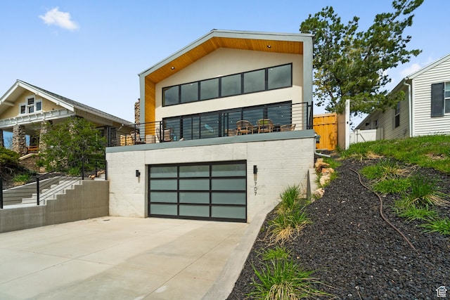 707 E 9th Ave, Salt Lake City, UT 84103 - modern home with a balcony, stucco siding, driveway, a garage, and fence