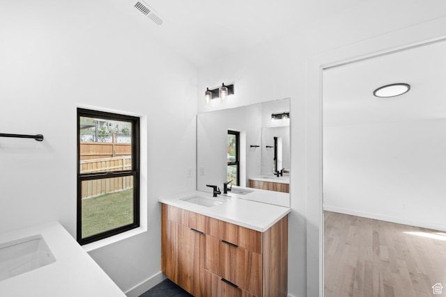 707 E 9th Ave, Salt Lake City, UT 84103 - full bath featuring visible vents, baseboards, vanity, and wood finished floors