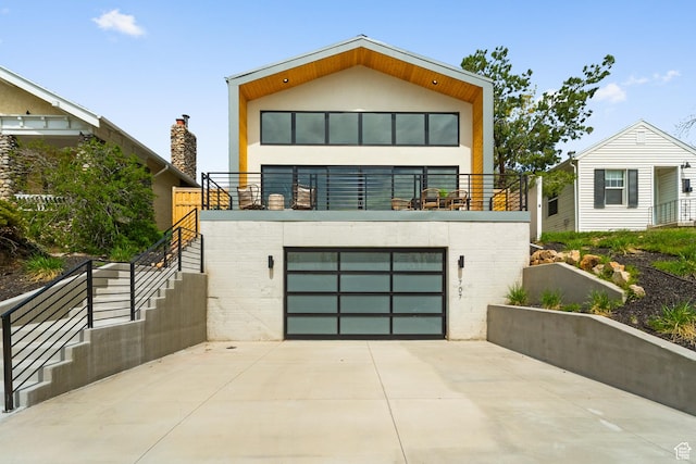 707 E 9th Ave, Salt Lake City, UT 84103 - modern home featuring brick siding, an attached garage, driveway, and stairs
