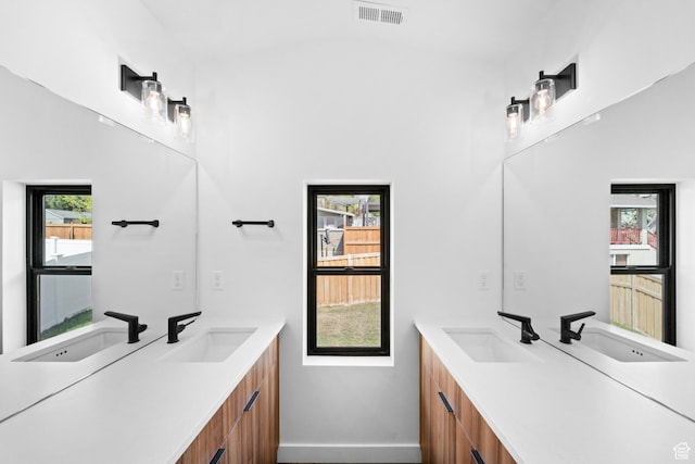 707 E 9th Ave, Salt Lake City, UT 84103 - bathroom featuring vanity, baseboards, vaulted ceiling, and visible vents