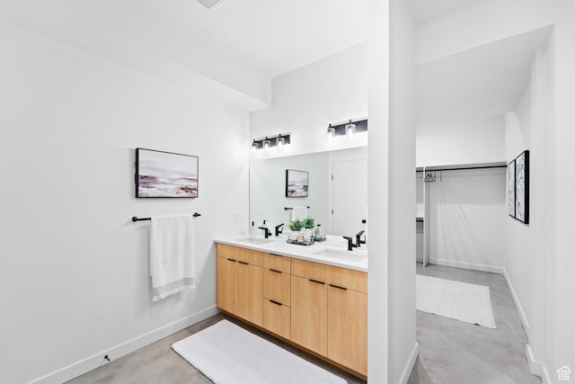 707 E 9th Ave, Salt Lake City, UT 84103 - bathroom featuring a sink, baseboards, double vanity, and concrete floors