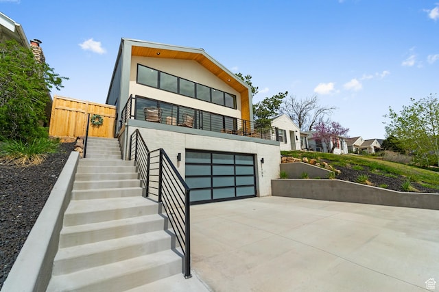 707 E 9th Ave, Salt Lake City, UT 84103 - contemporary house with concrete driveway, stairway, and an attached garage