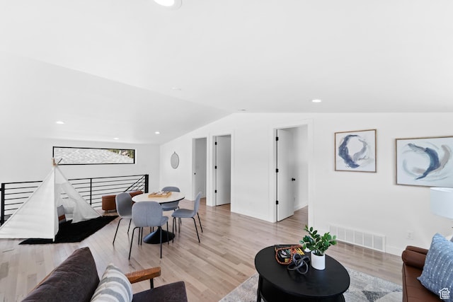 707 E 9th Ave, Salt Lake City, UT 84103 - living room featuring visible vents, baseboards, light wood-type flooring, and vaulted ceiling