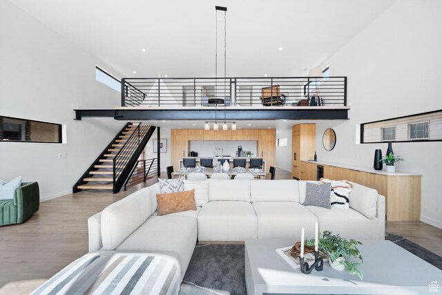 707 E 9th Ave, Salt Lake City, UT 84103 - living area with stairs, a high ceiling, baseboards, and wood finished floors