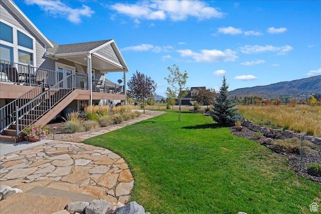 view of yard with a mountain view and stairs